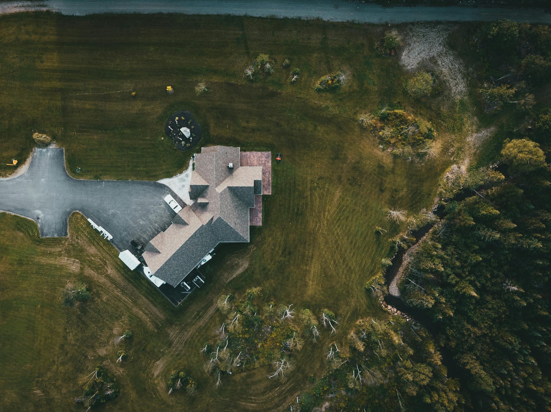 A house on a large lot, seen from above.