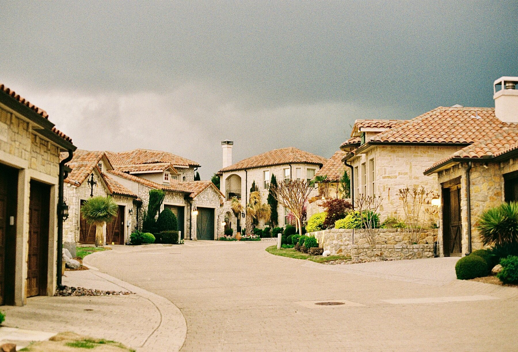 Two neighboring houses sharing a street.