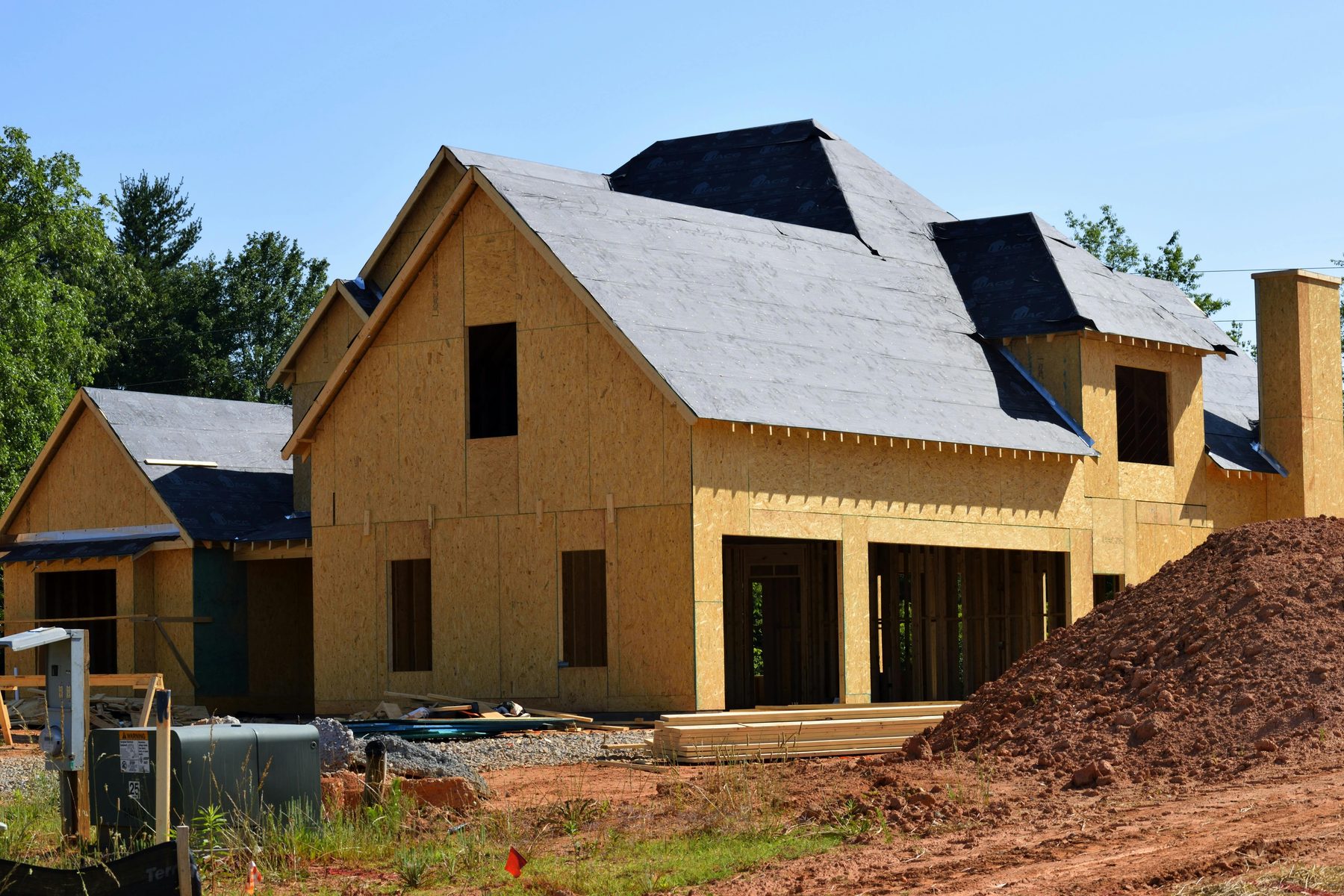 A custom home taking shape on a residential lot.