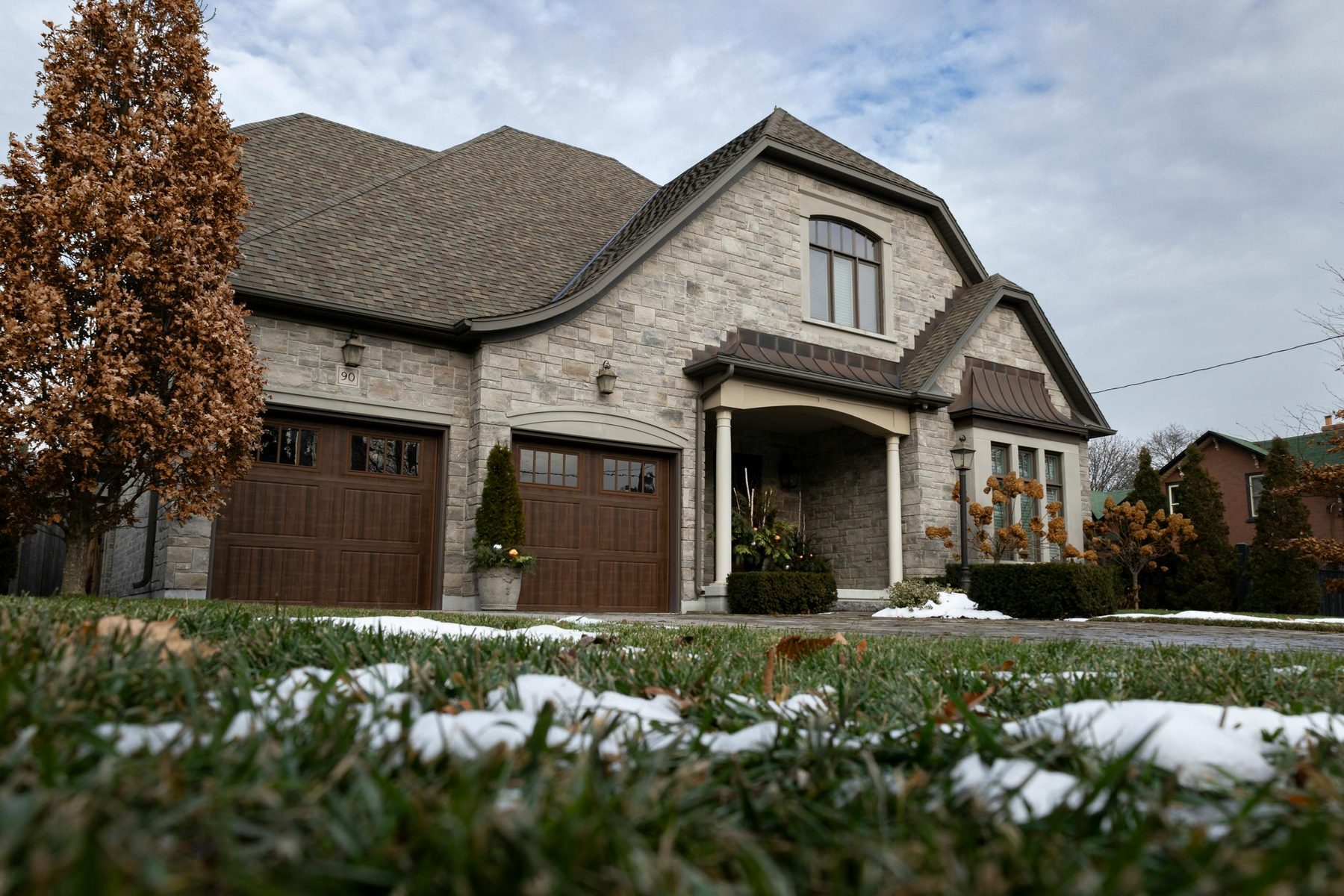An established stone home on its lot.