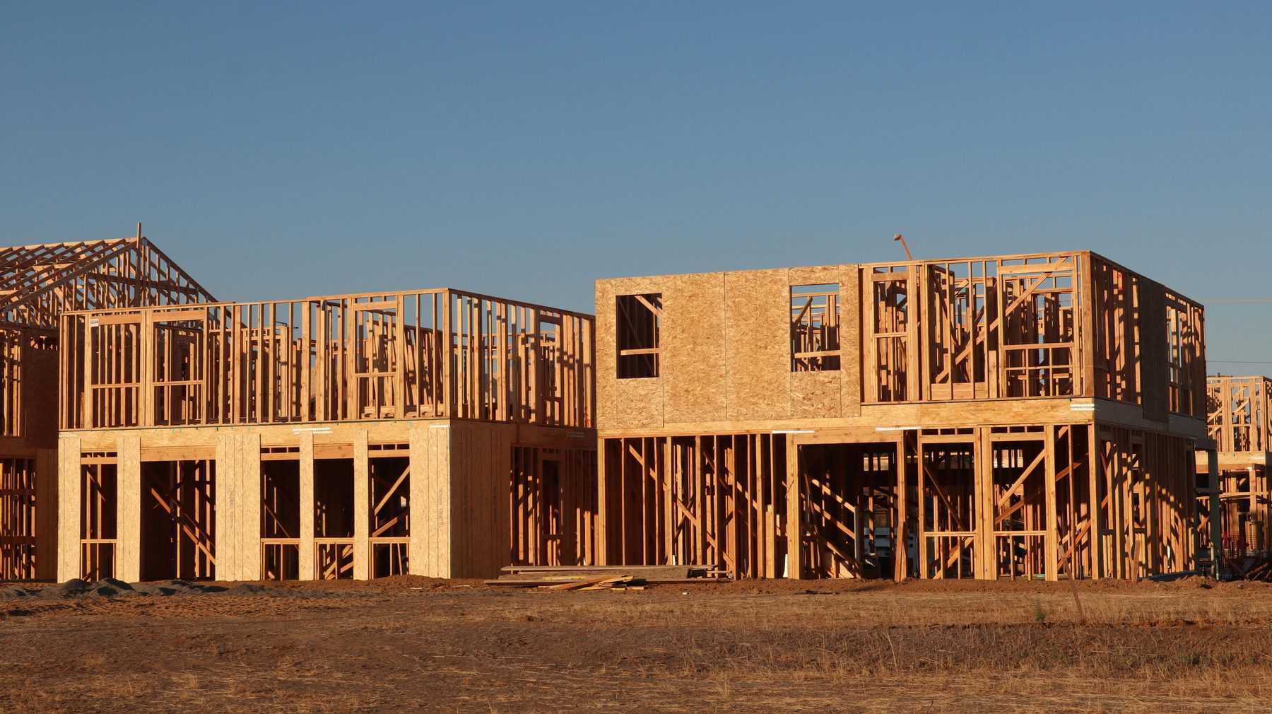 New construction framing on an open lot.