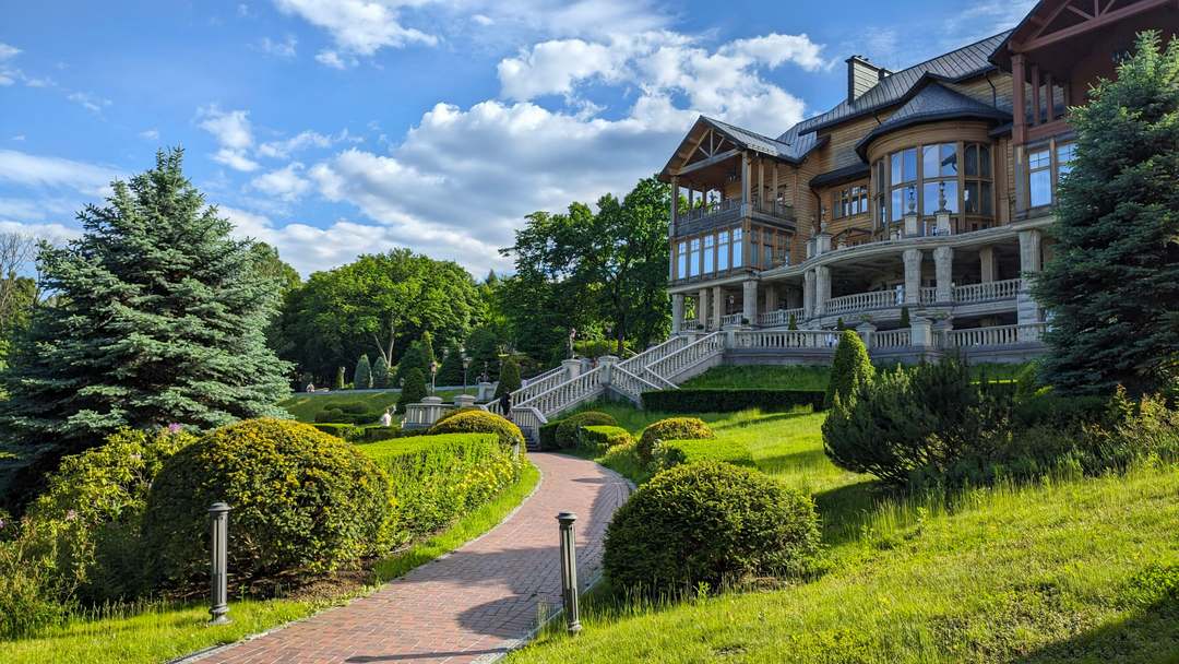 A luxury home on a manicured lot under a clear sky.